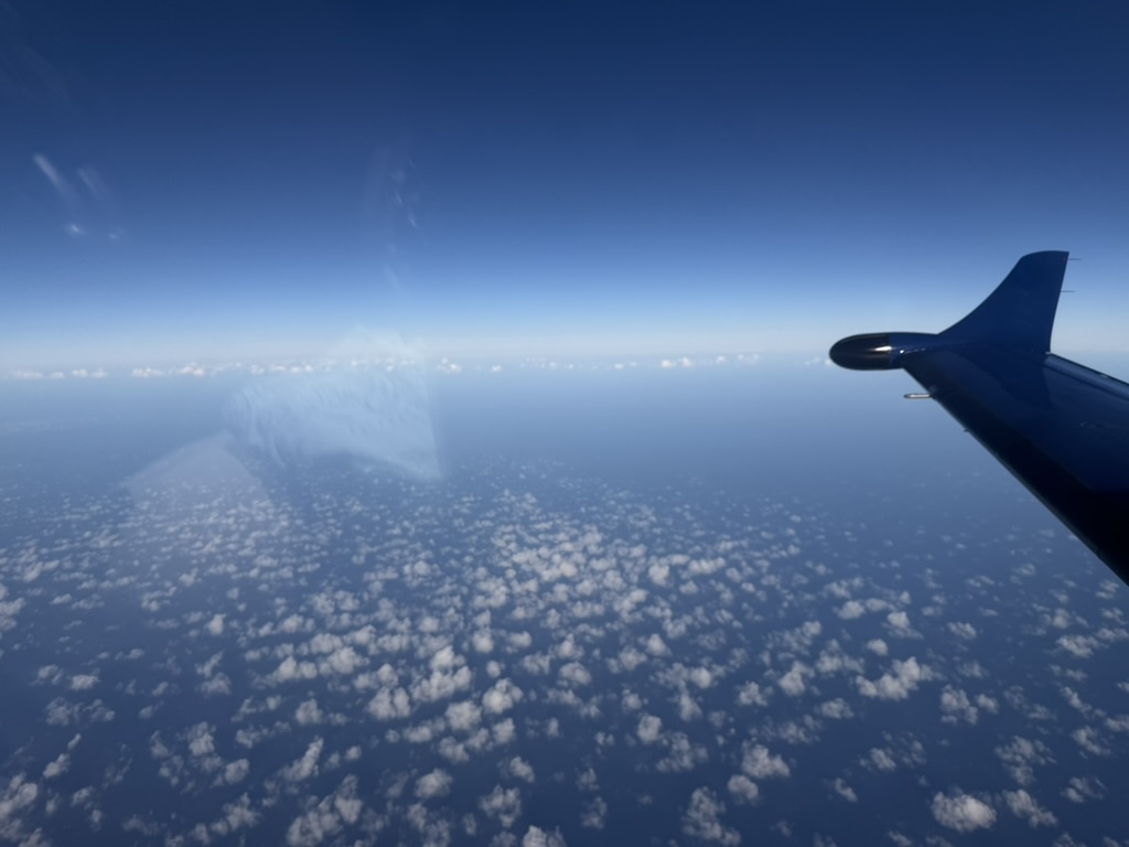 Pilatus wing in flight above the clouds